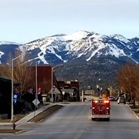 ambulance driving with lights with mountains in the background