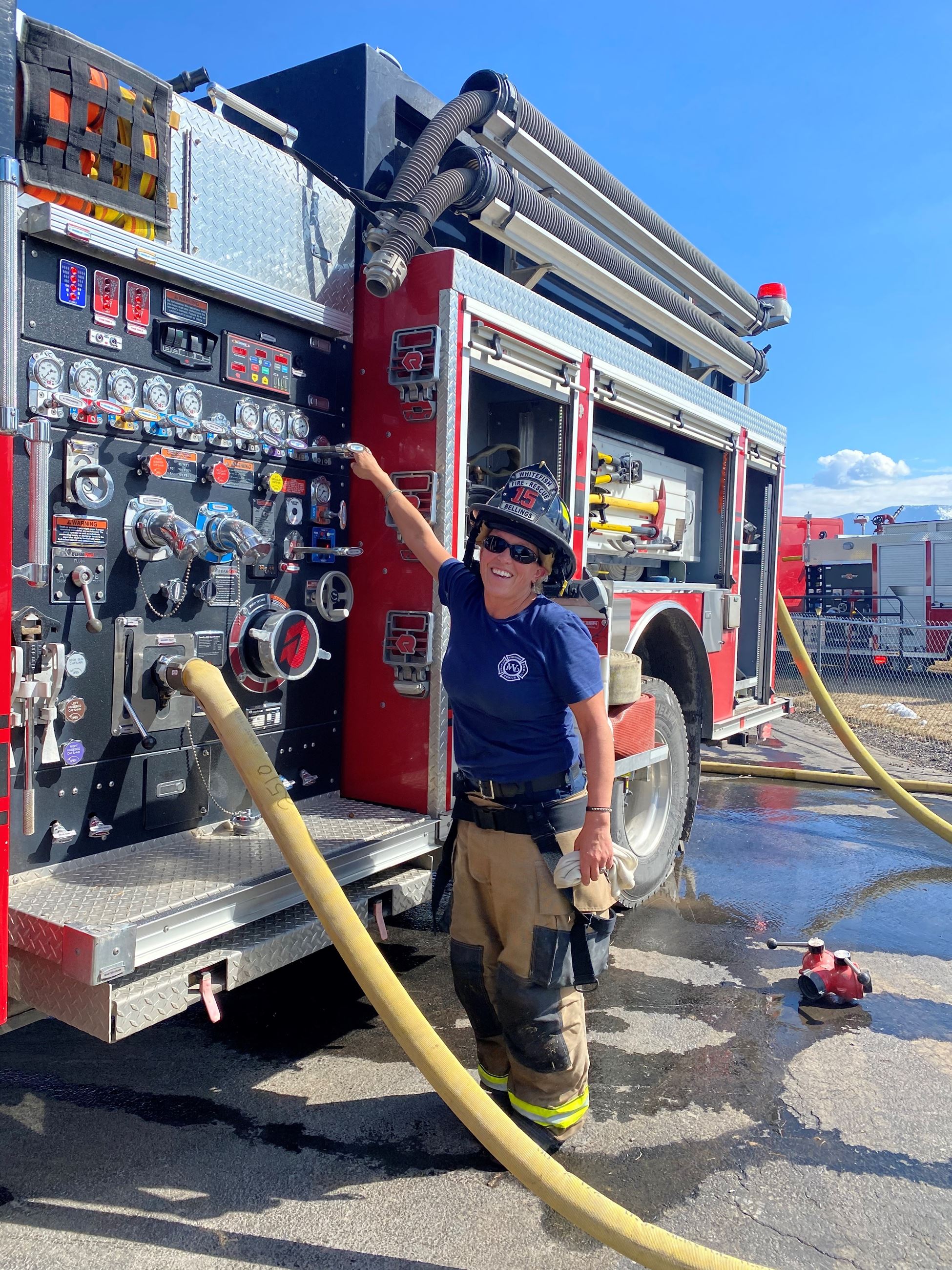 Firefighter operating red fire engine number 231